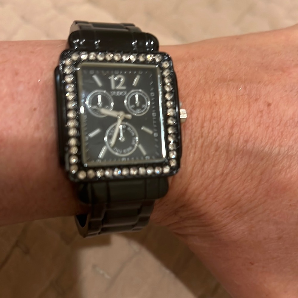 Black cuff style watch with crystal bezel